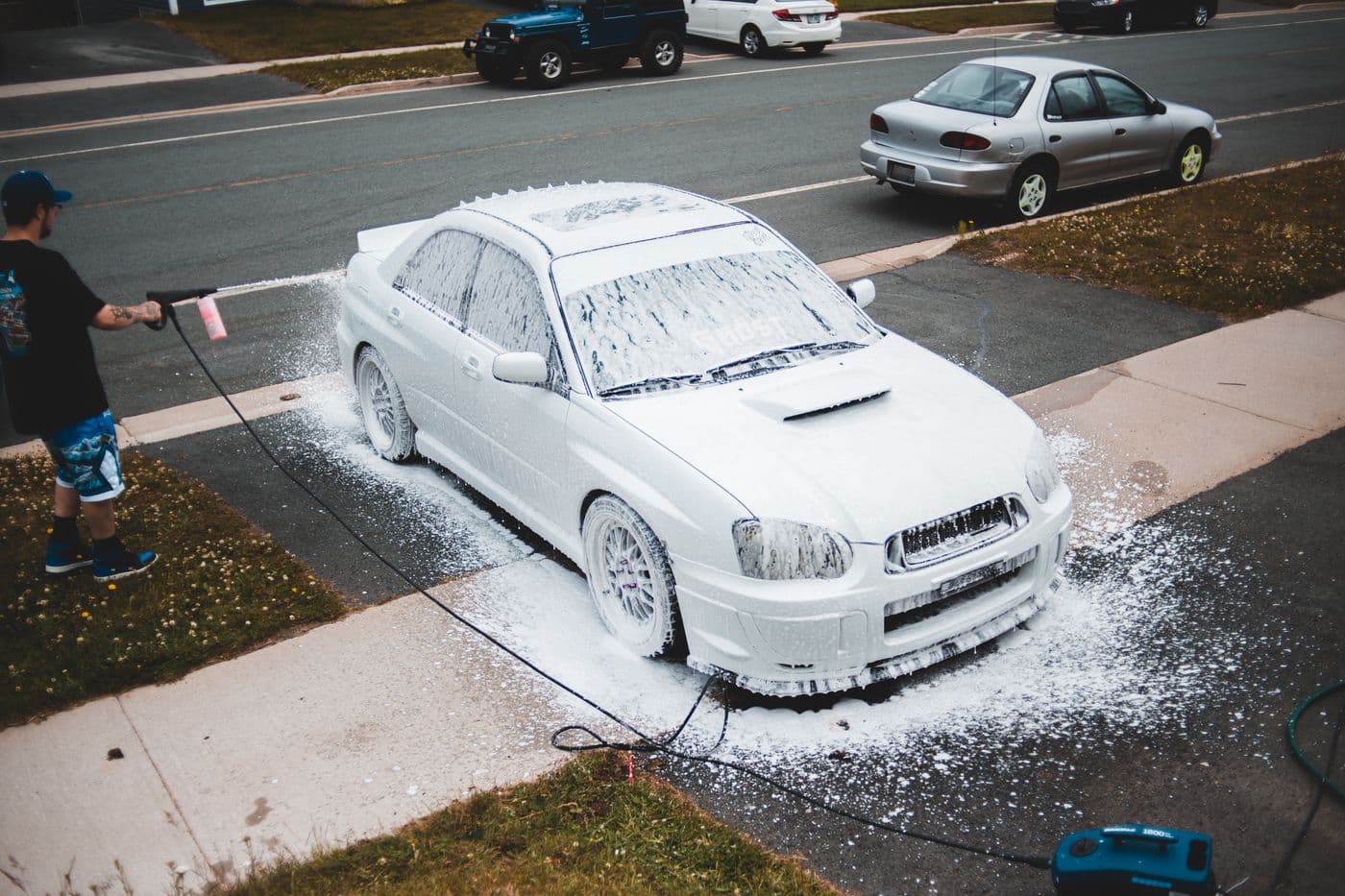 A car being washed on a residential driveway