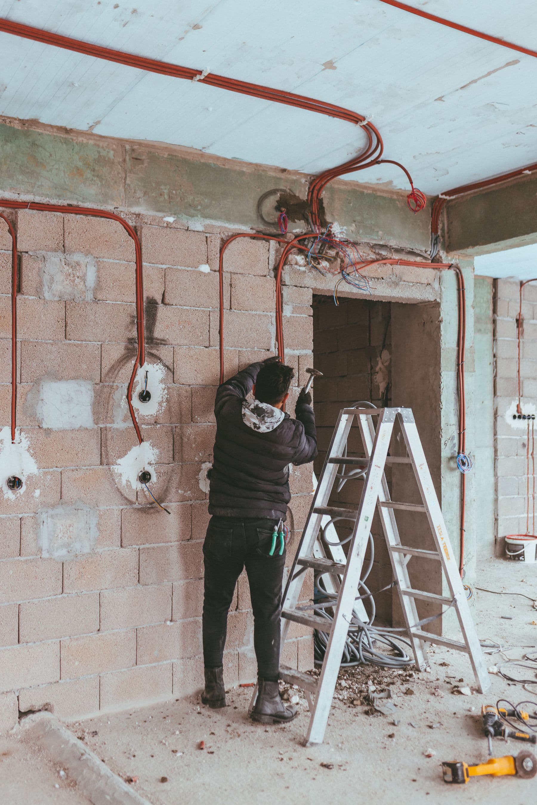 Electrical worker fitting wiring during a building renovation